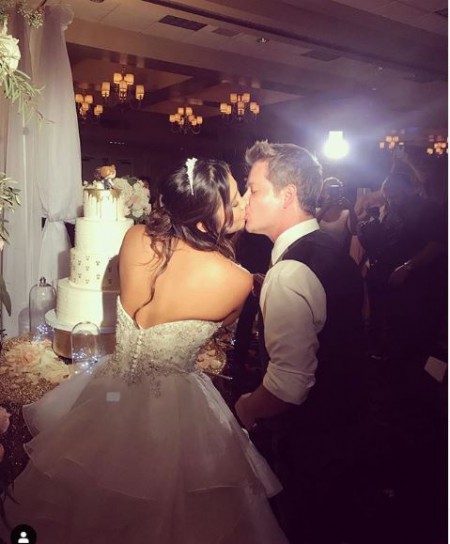 Katie Drysen kissing her husband Jason Earles on the lips at their wedding